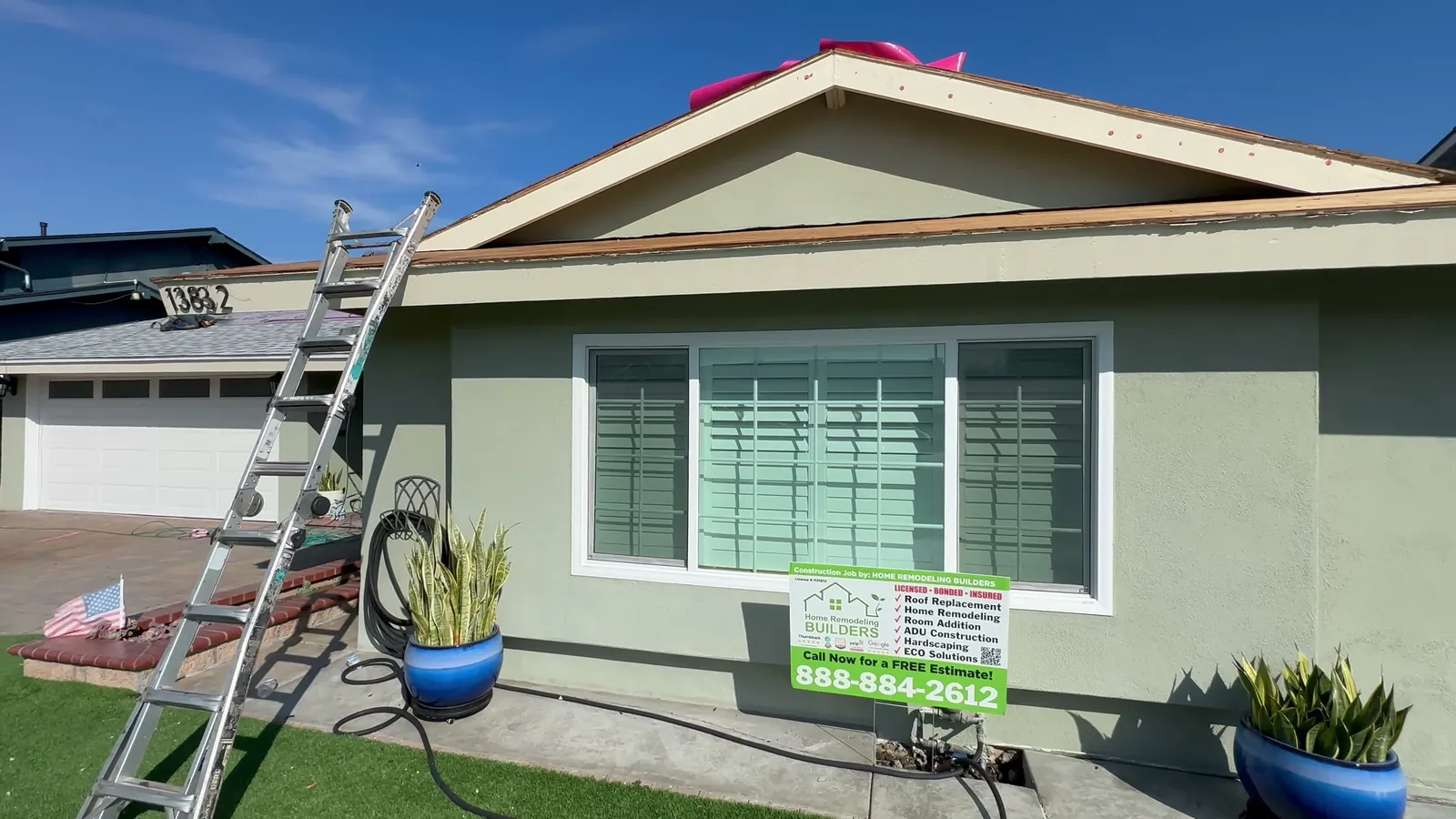 Roof preparation above the front window and company jobsite sign. Westminster roofing project.