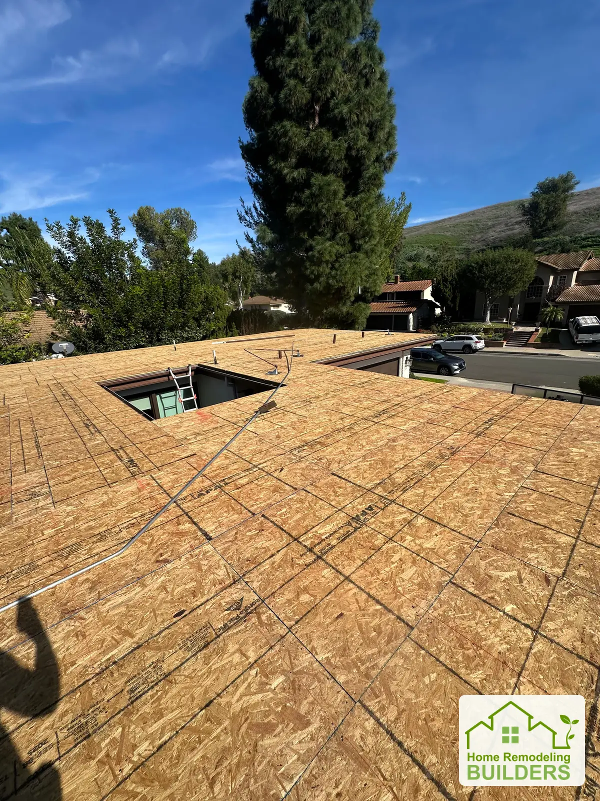 New roof sheathing installed around the skylight. Whittier Â· Flat roof roofing project.