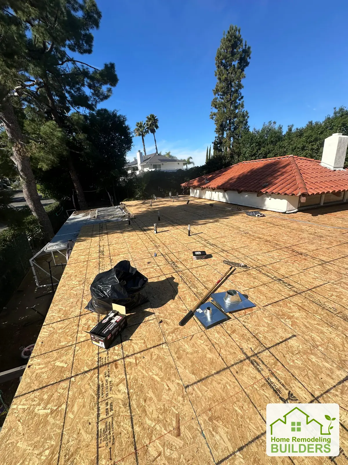 New sheathing across the opposite roof section. Whittier Â· Flat roof roofing project.