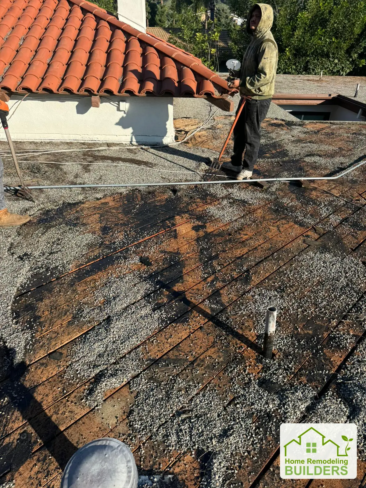 Removal work at the junction with the tile roof. Whittier Â· Flat roof roofing project.