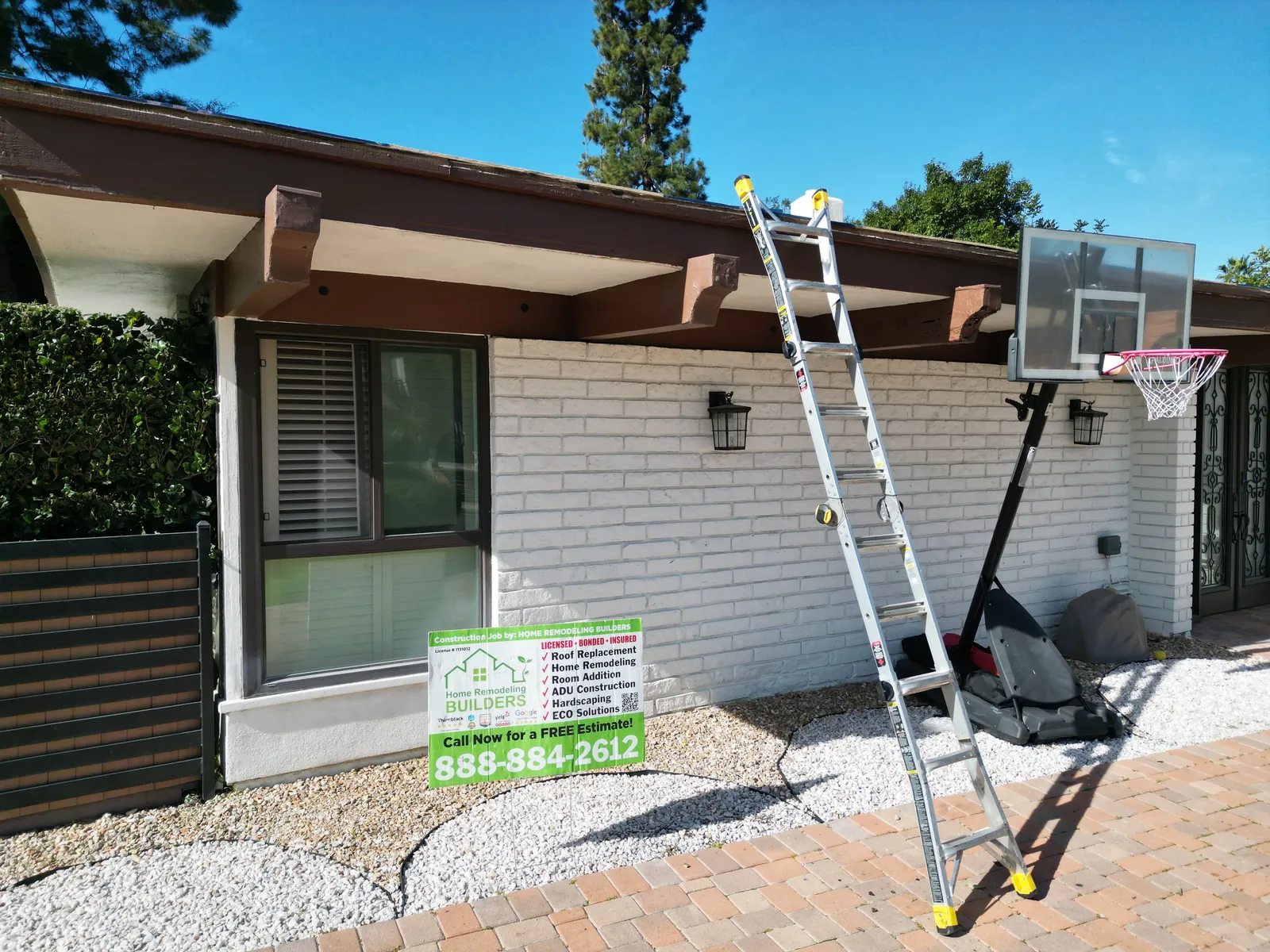 The company sign and roof access at the Whittier jobsite. Whittier Â· Flat roof roofing project.
