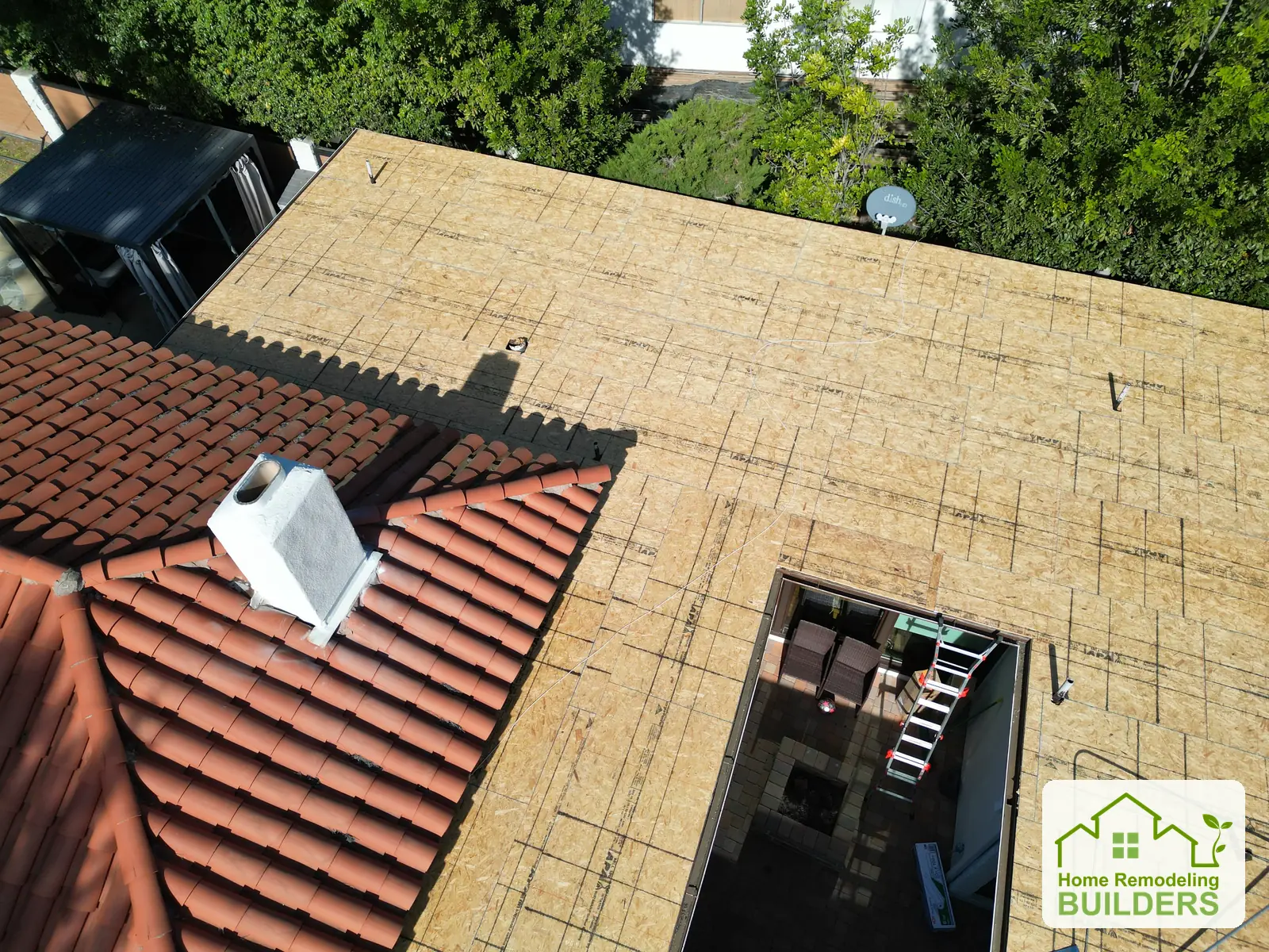 The skylight and tile-roof junction seen from above. Whittier Â· Flat roof roofing project.